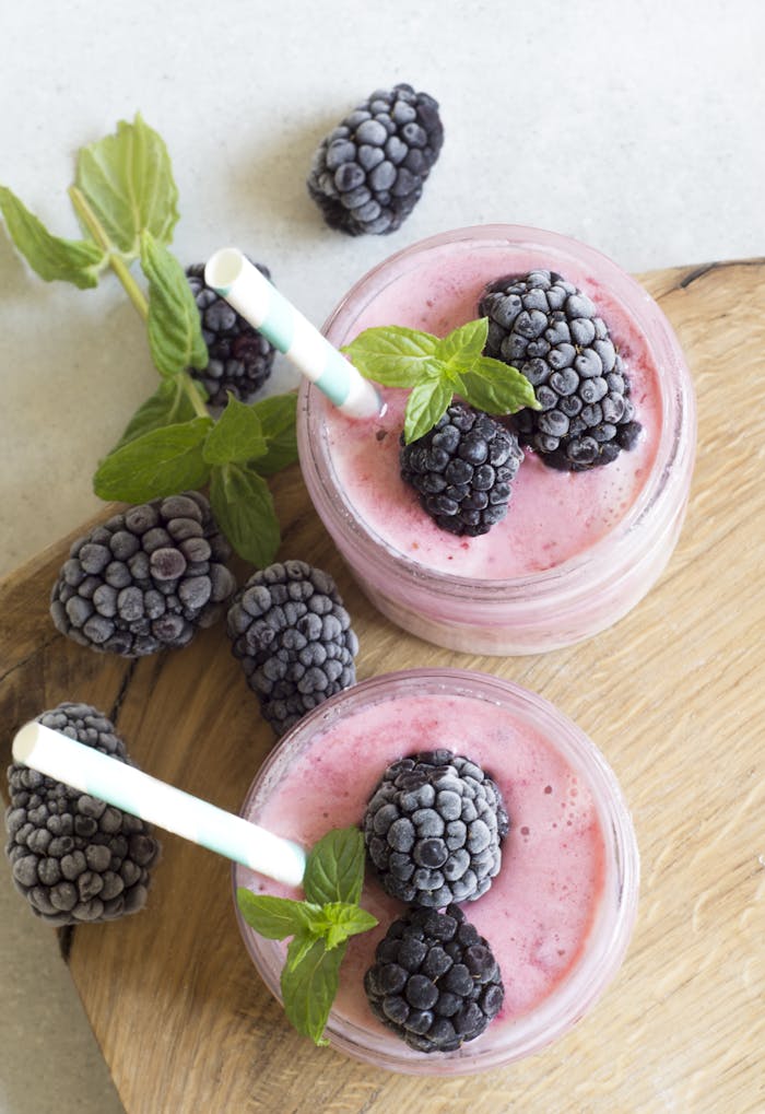 our-story Enjoy a refreshing blackberry smoothie topped with fresh mint leaves, perfect for a summer treat.